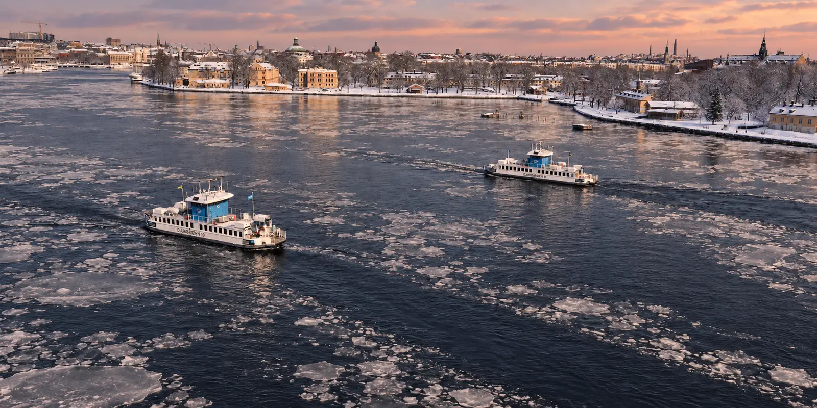 Ferries crossing Stockholm’s icy waterfront in winter