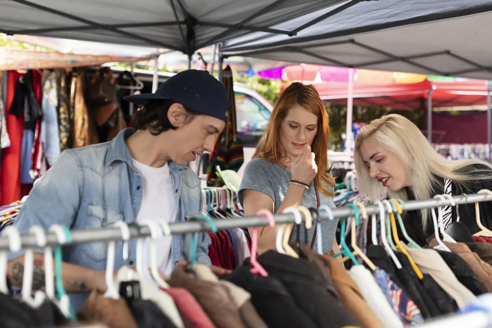 Visitors browsing clothing racks at Hornstulls Marknad