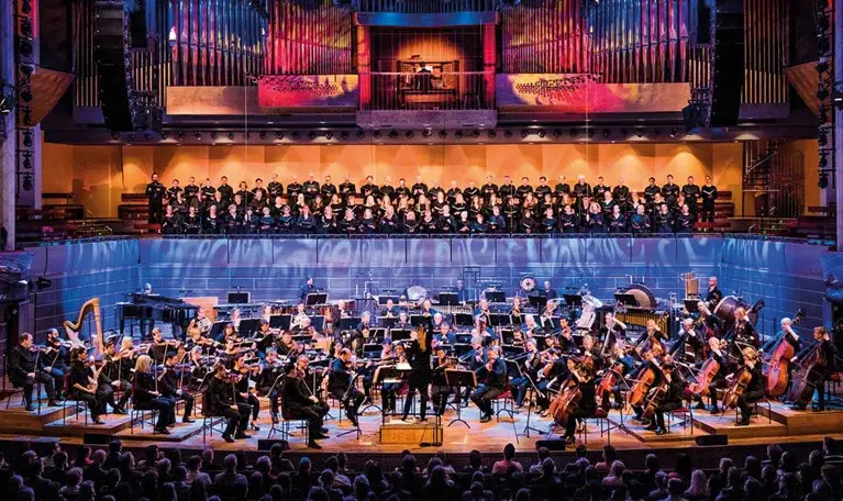 Orchestra and choir performing inside Konserthuset
