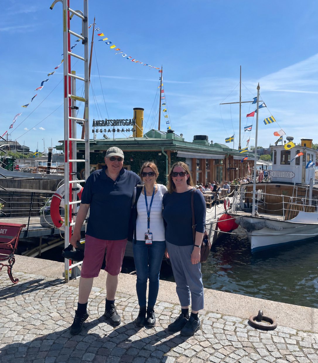 Sara Bulgheroni with guests by boats in Stockholm harbor