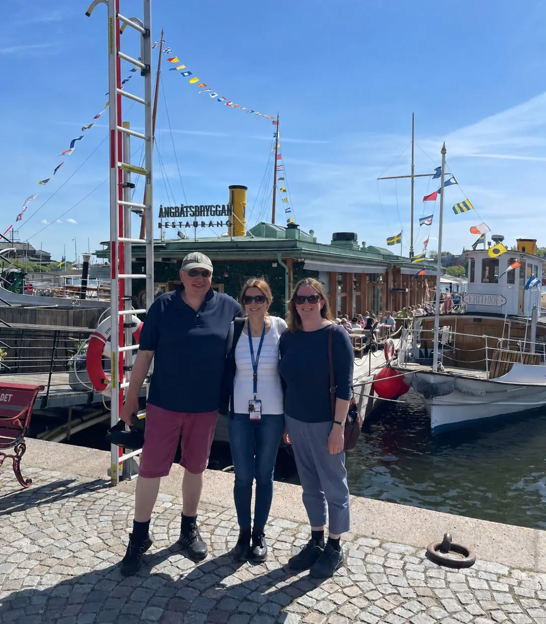 Sara Bulgheroni with guests by boats in Stockholm harbor
