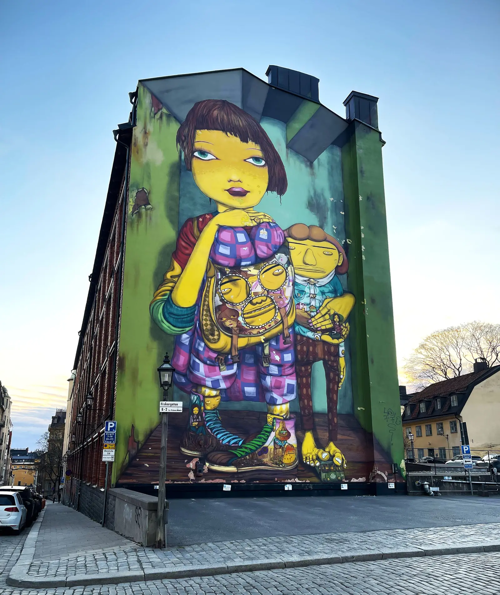 Large colorful mural on a building facade in Södermalm
