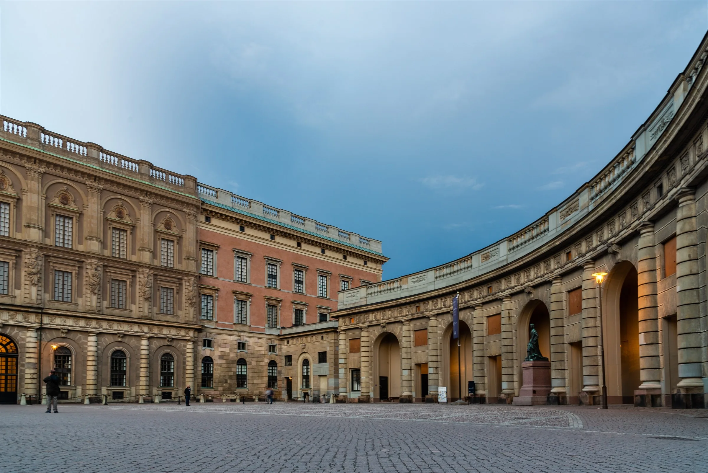 Evening view across the Royal Palace courtyard under a blue sky