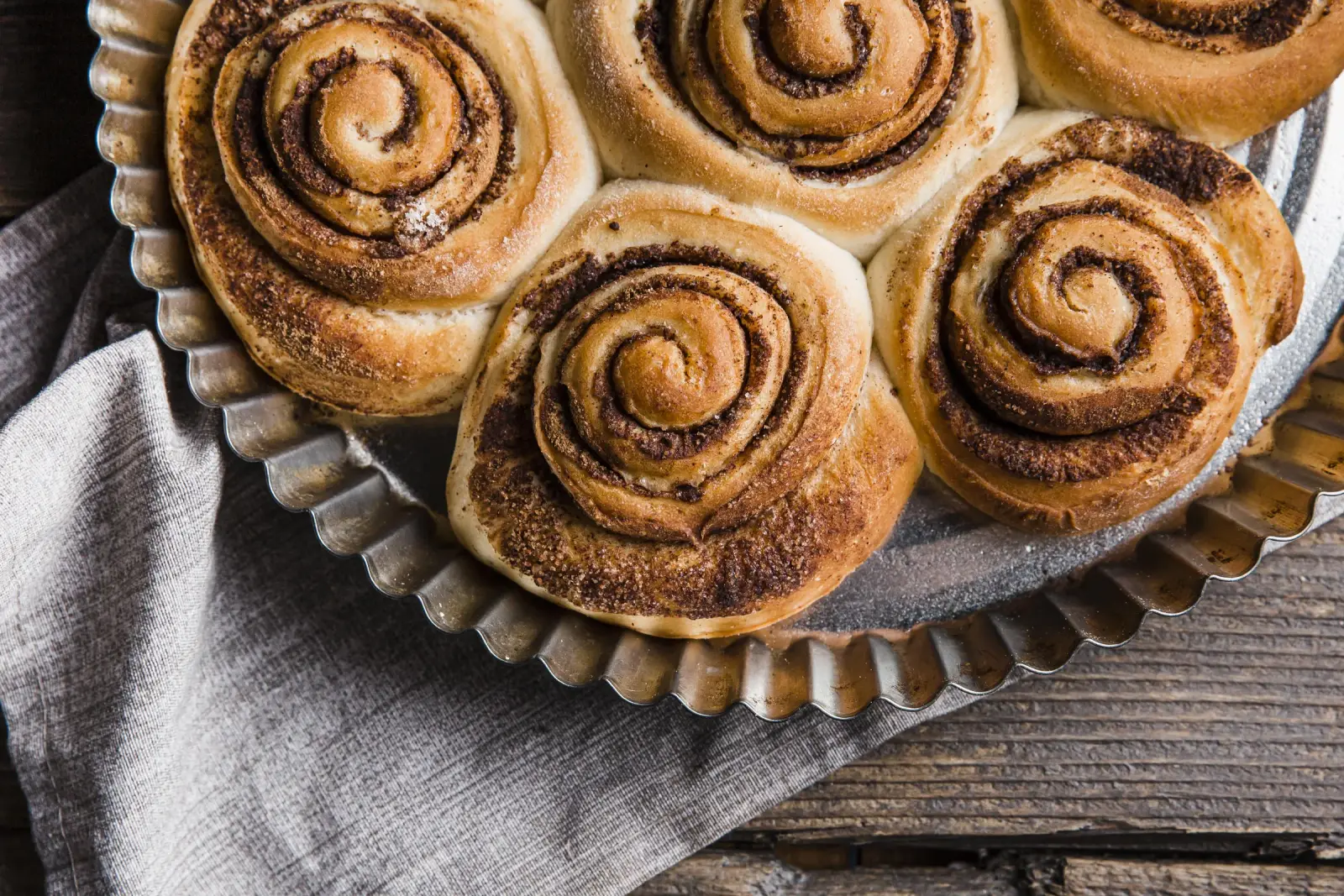 Fresh cinnamon buns arranged in a baking pan for fika