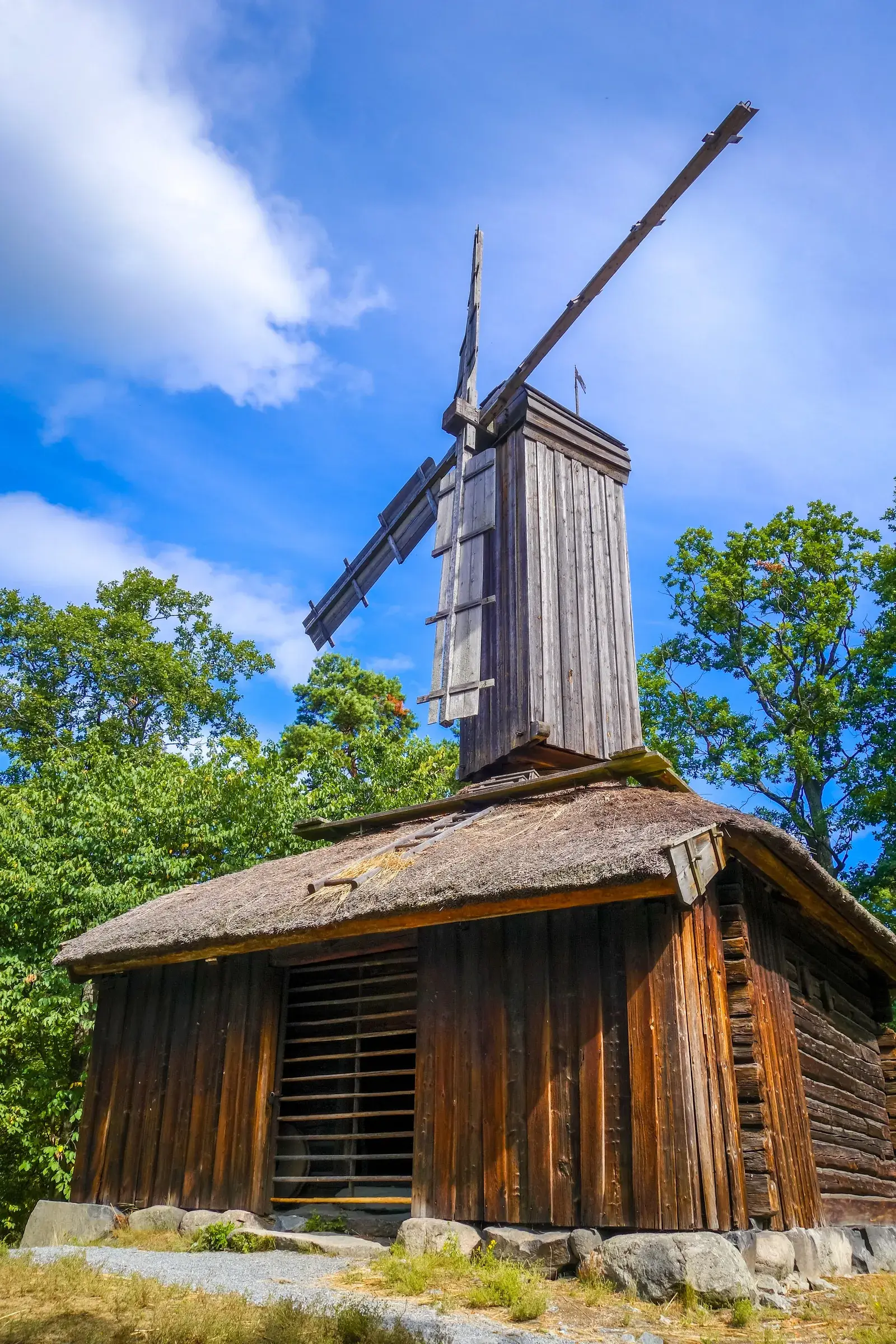Traditional windmill and historic wooden building at Skansen in Stockholm