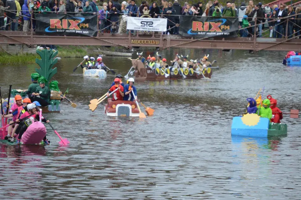 Homemade rafts drifting down the Fyris River during Valborg celebrations in Uppsala
