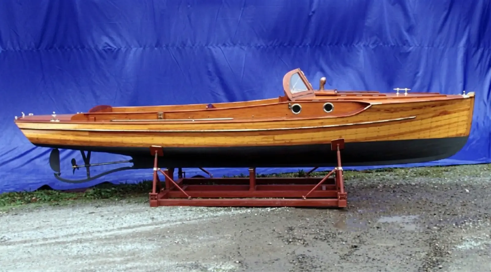 Classic Pettersson wooden boat shown on a stand
