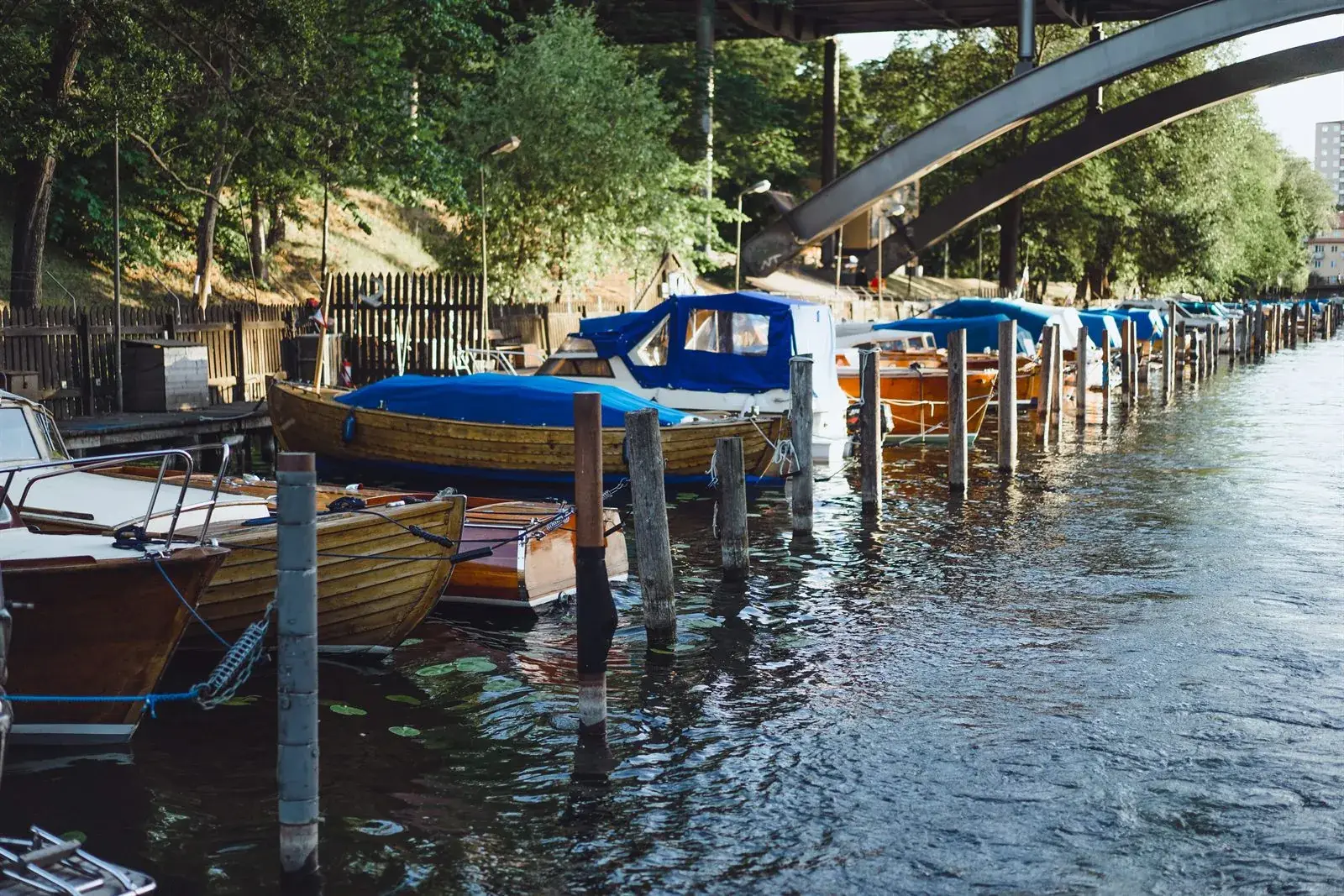 Row of classic wooden boats moored along the water at Sodermalm